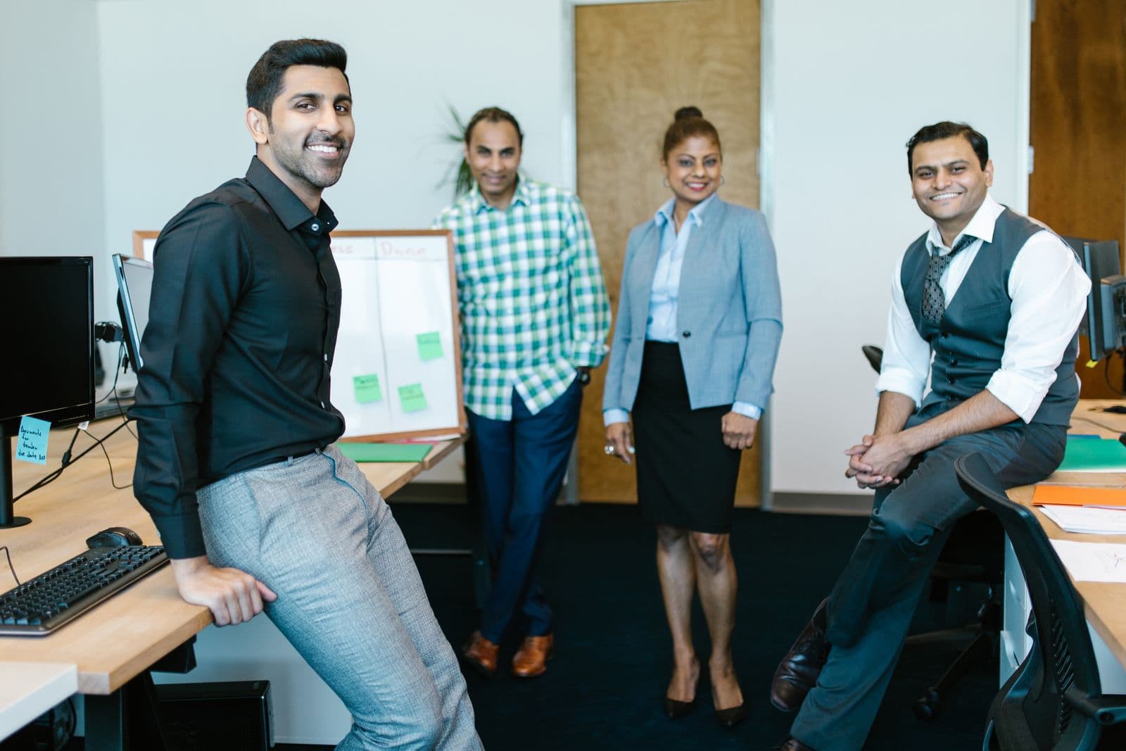 A diverse Vsolwit team collaborating and smiling together